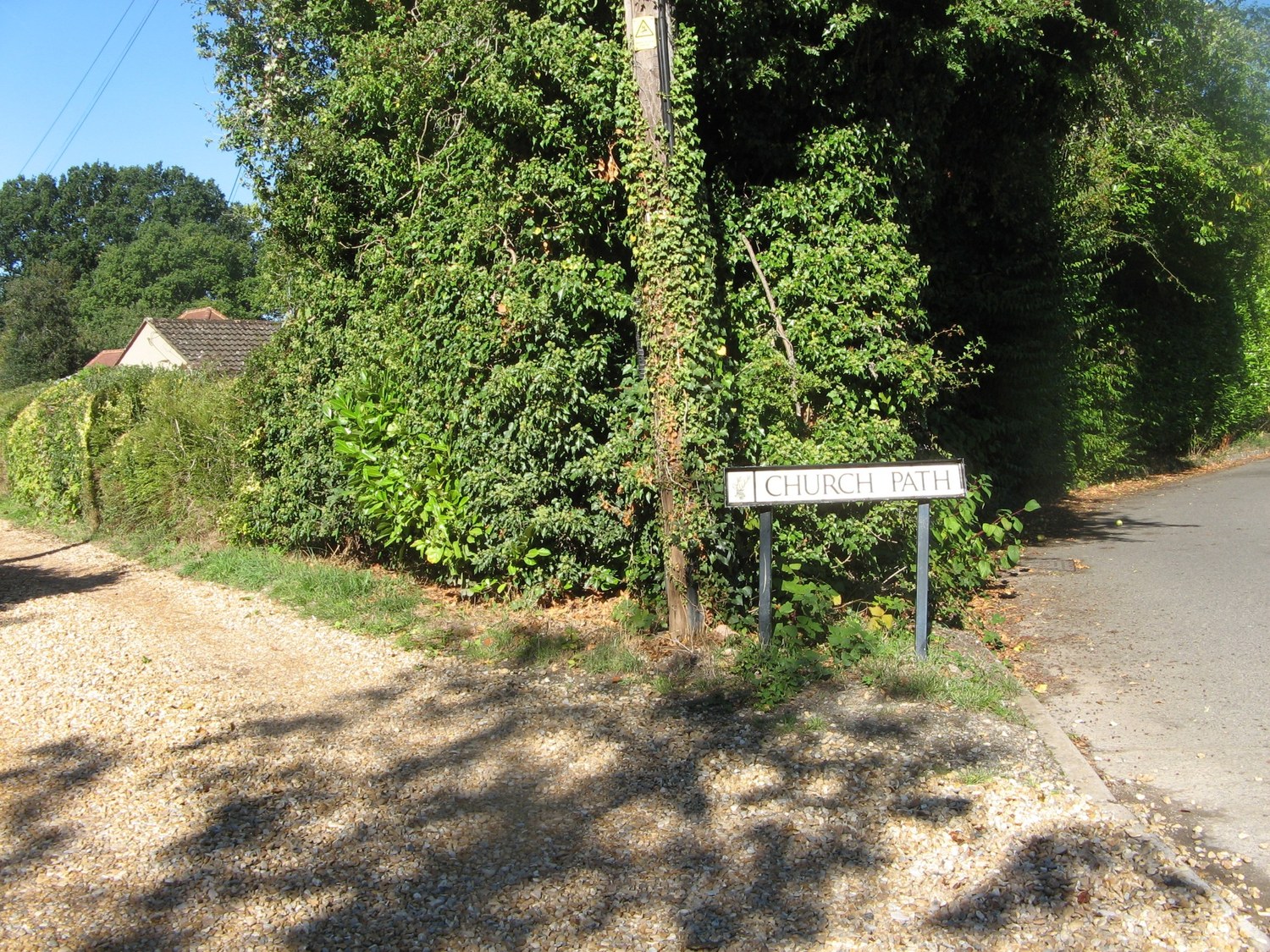 Church Path sign under leafy trees at Hook